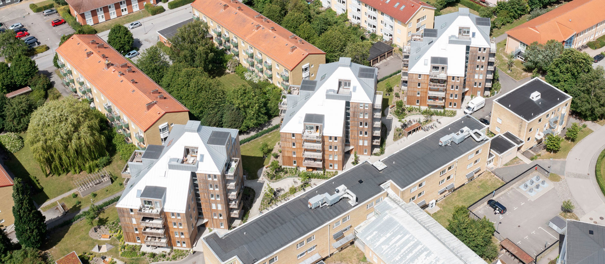 Grönalund. Tre hus i sju våningar med träfasad. 